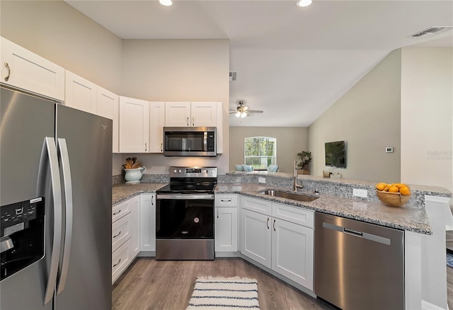 kitchen with stainless steel appliances, white cabinetry, and sink