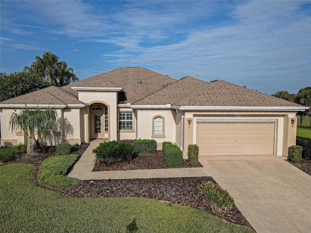 single story home featuring a garage and a front lawn