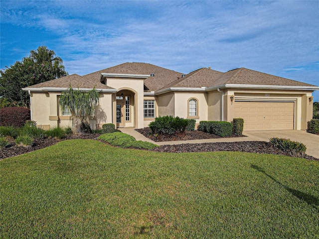 view of front of home featuring a garage and a front lawn