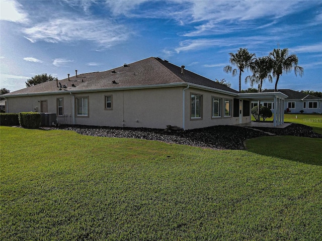 rear view of house with a lawn and a patio area