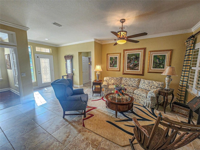 tiled living room featuring ceiling fan, ornamental molding, and a textured ceiling