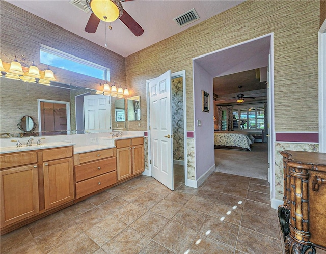 bathroom with tile patterned flooring, vanity, and ceiling fan