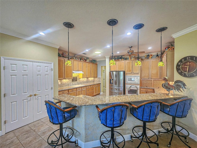 kitchen featuring light tile patterned floors, white microwave, kitchen peninsula, stainless steel fridge with ice dispenser, and a breakfast bar