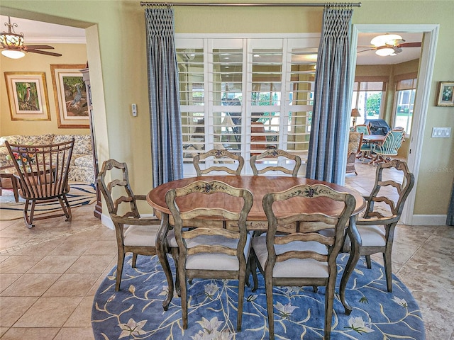 dining space featuring ceiling fan, ornamental molding, and tile patterned floors