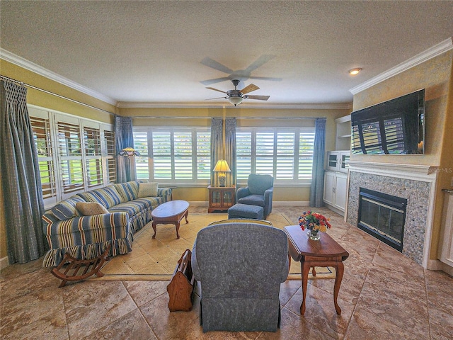 living room featuring ceiling fan, crown molding, and a textured ceiling