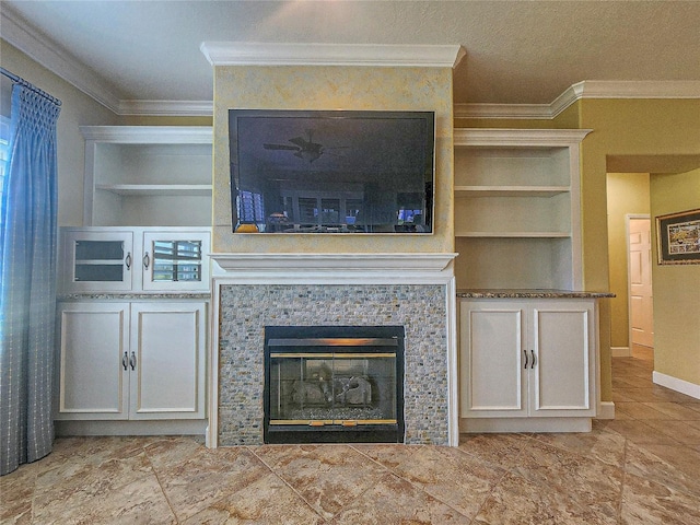 unfurnished living room featuring ornamental molding, a textured ceiling, and built in shelves