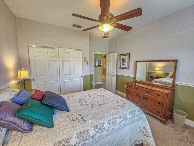 carpeted bedroom with a closet, ceiling fan, and vaulted ceiling