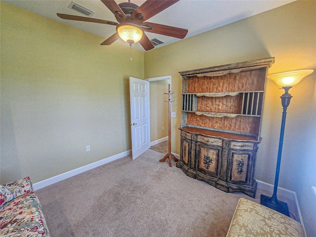 unfurnished living room featuring carpet flooring and ceiling fan