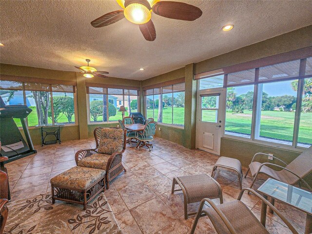 sunroom featuring ceiling fan