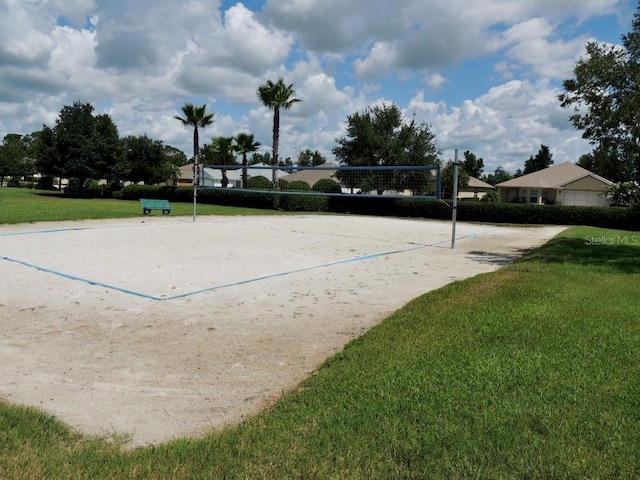 surrounding community featuring a yard and volleyball court