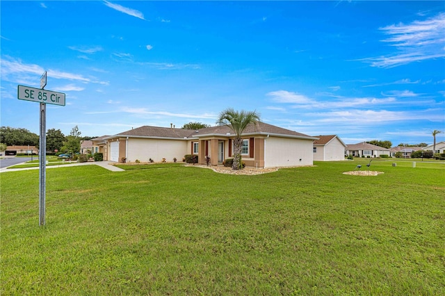 view of front of home featuring a front yard and a garage