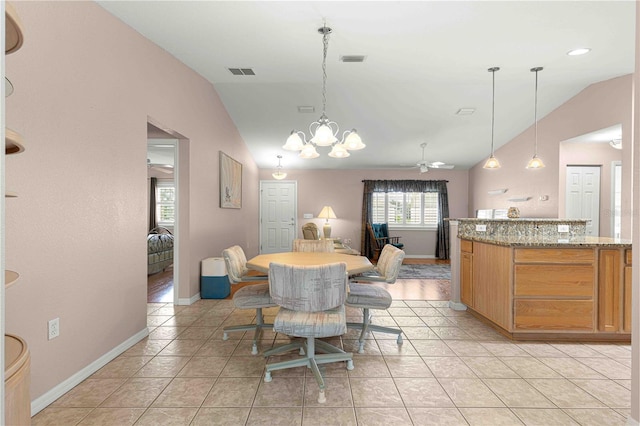 dining room featuring ceiling fan with notable chandelier, vaulted ceiling, and light tile patterned floors