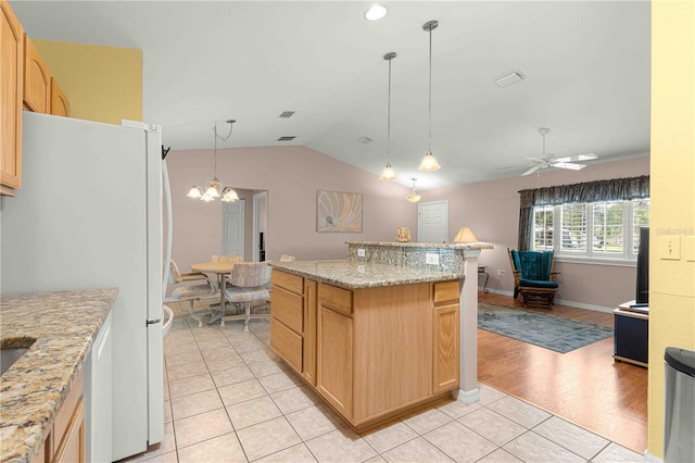 kitchen with white refrigerator, light hardwood / wood-style floors, ceiling fan with notable chandelier, lofted ceiling, and hanging light fixtures