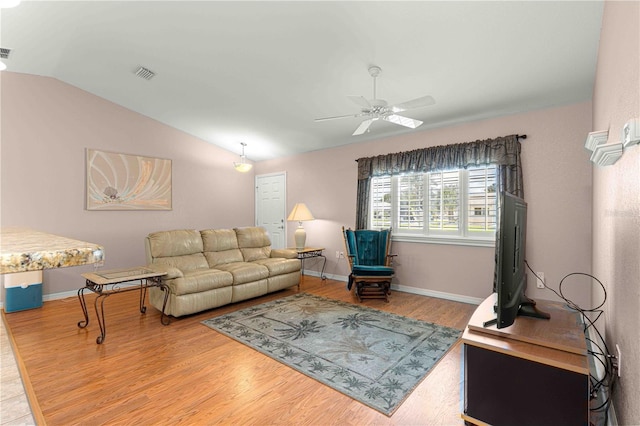 living room with vaulted ceiling, ceiling fan, and hardwood / wood-style flooring