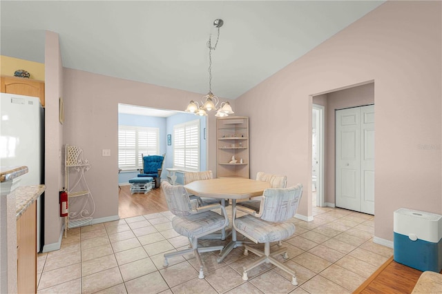 dining area featuring light hardwood / wood-style flooring and a chandelier