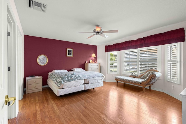 bedroom with ceiling fan and wood-type flooring