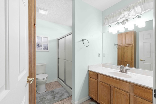 bathroom featuring tile patterned floors, an enclosed shower, vanity, and toilet