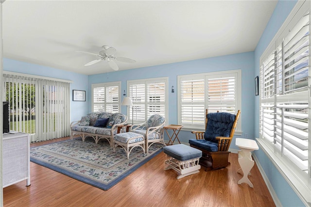 living room featuring hardwood / wood-style flooring, ceiling fan, and a wealth of natural light