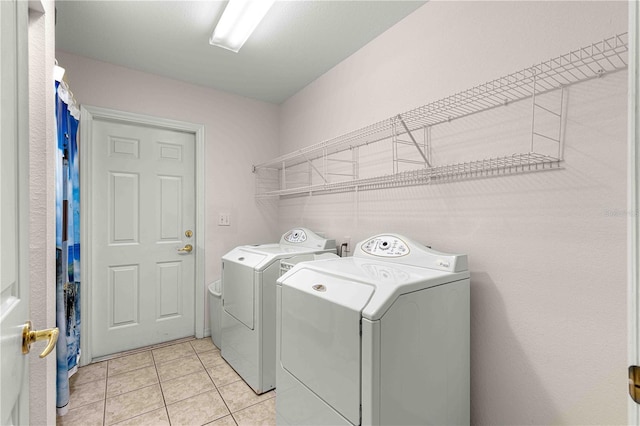 laundry area with light tile patterned floors and independent washer and dryer