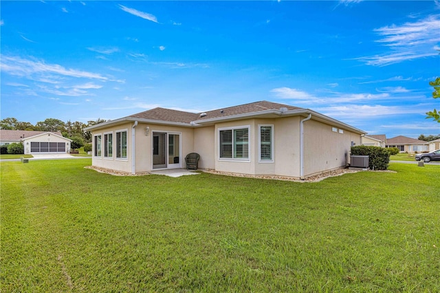 back of house featuring a lawn, a sunroom, and central AC