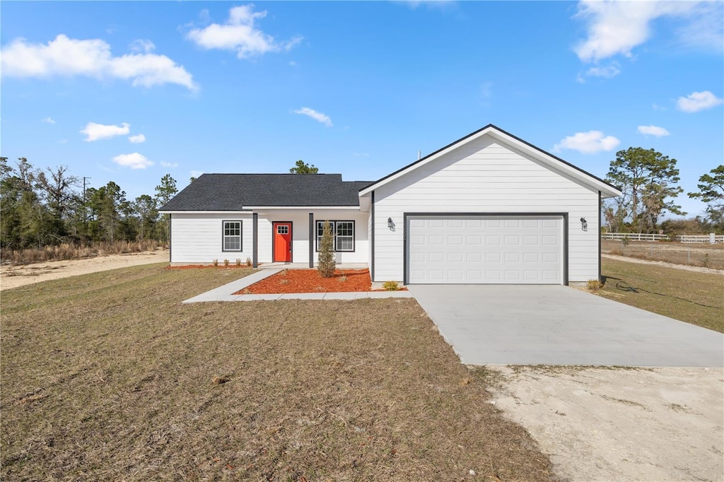 ranch-style house with a garage and a front lawn