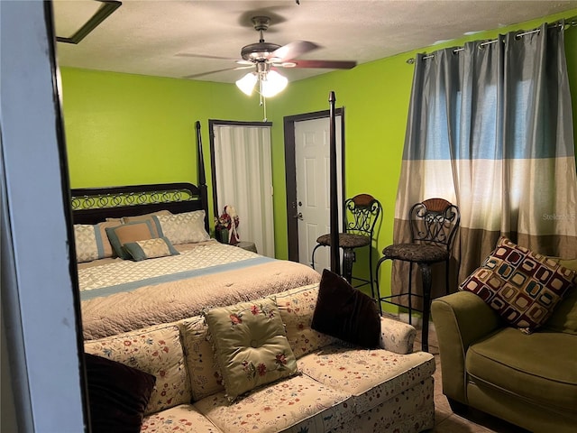 bedroom with ceiling fan and a textured ceiling