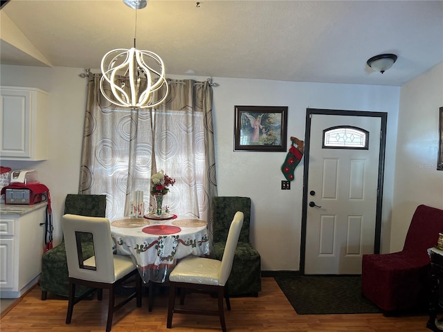 dining room with an inviting chandelier and hardwood / wood-style flooring