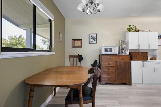 dining room featuring a chandelier and light hardwood / wood-style floors