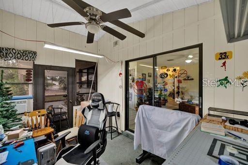 office space with cooling unit and ceiling fan