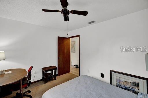 bedroom featuring a textured ceiling, carpet flooring, and ceiling fan