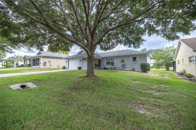 ranch-style house with a garage and a front lawn