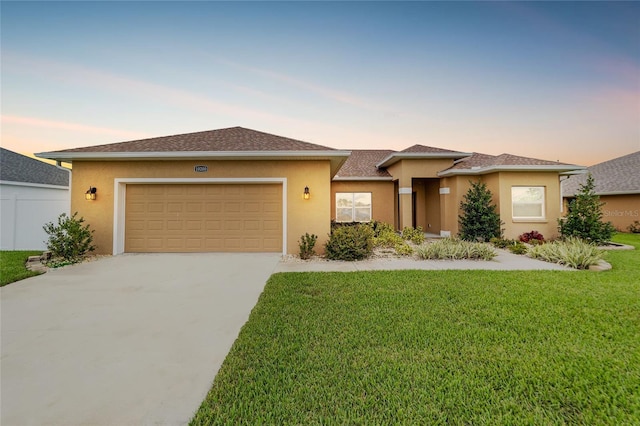 prairie-style house with a garage and a yard