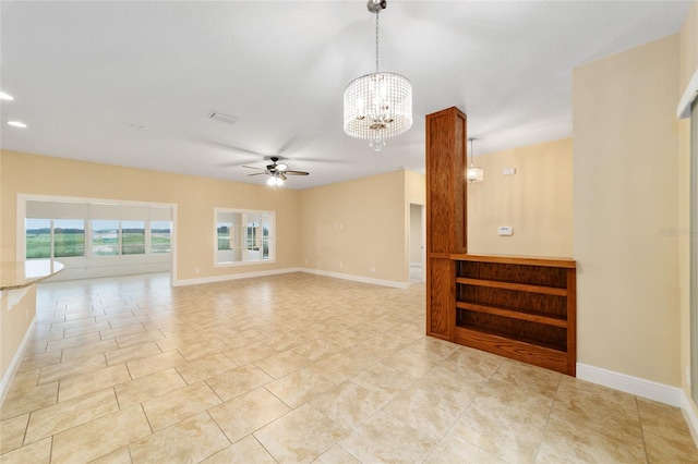 unfurnished living room featuring ceiling fan with notable chandelier