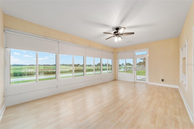 spare room featuring ceiling fan and light hardwood / wood-style floors