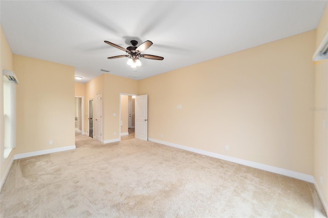 carpeted spare room featuring ceiling fan