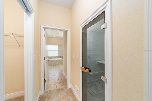 corridor with light tile patterned floors