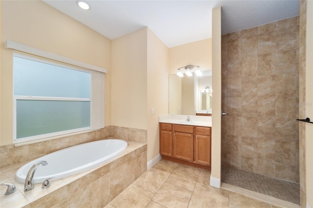 bathroom featuring vanity, tile patterned flooring, and shower with separate bathtub