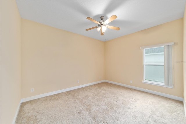 empty room featuring light colored carpet and ceiling fan