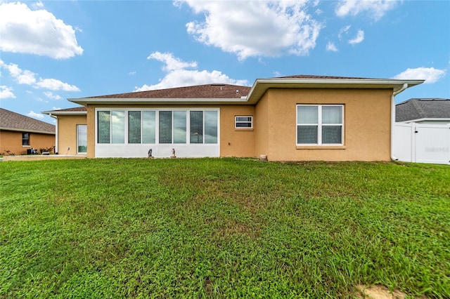 rear view of property with a yard