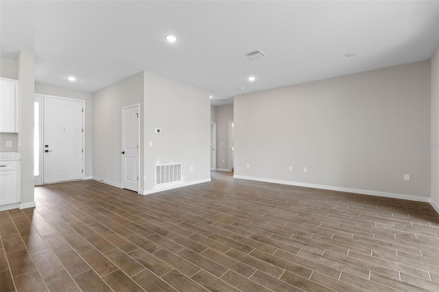 unfurnished living room featuring dark wood-type flooring