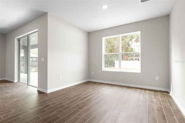 empty room with dark wood-type flooring