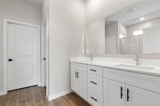 bathroom featuring vanity and a shower with shower door