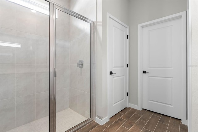 bathroom with a shower with door