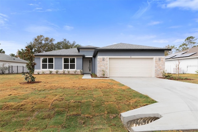 view of front of home featuring a front yard and a garage