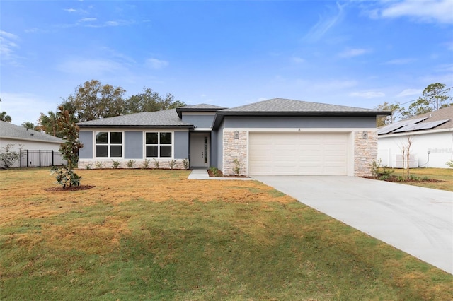 view of front of home featuring a garage and a front yard