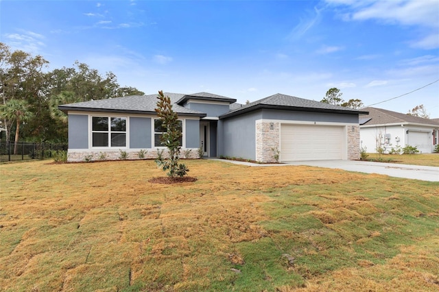 view of front of property with a front yard and a garage