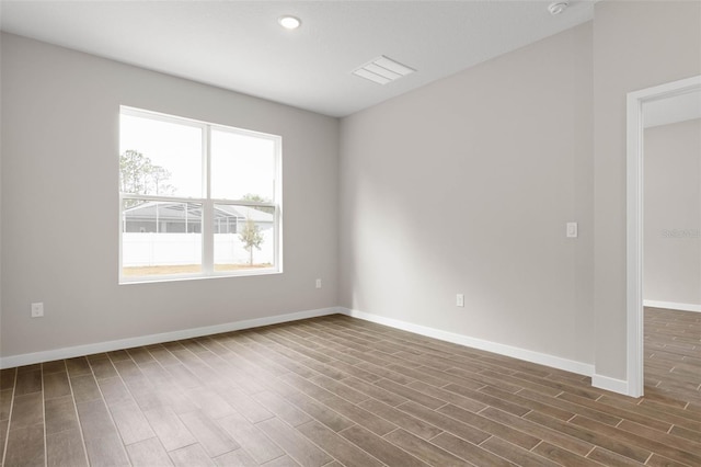 spare room featuring dark wood-type flooring