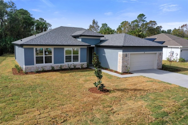 prairie-style home with a front yard and a garage