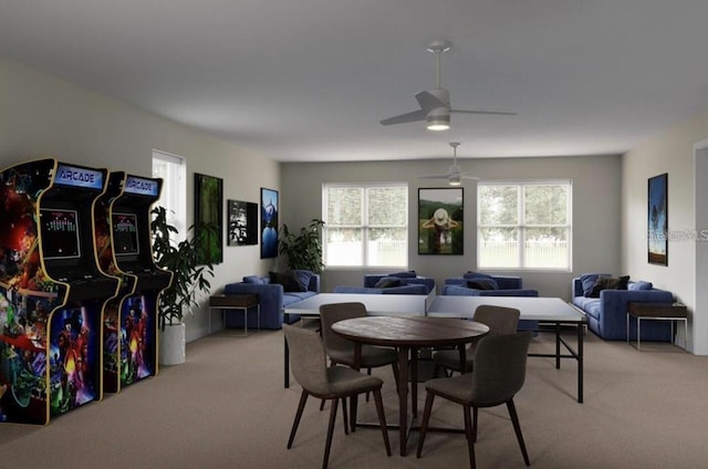 dining room featuring a wealth of natural light, light colored carpet, and ceiling fan