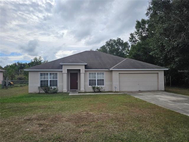 ranch-style house with fence, driveway, an attached garage, stucco siding, and a front lawn